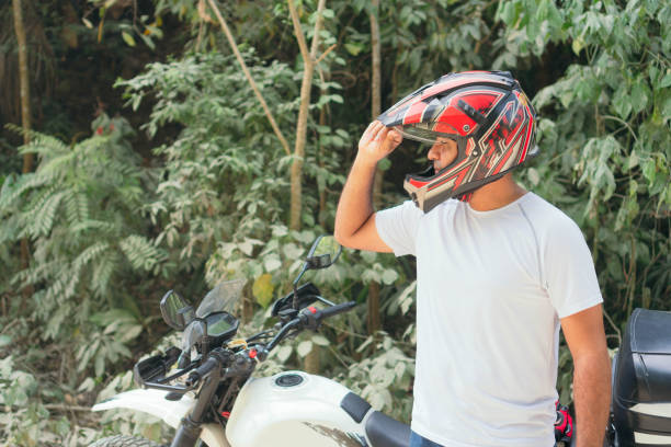 istock Man Putting On A Helmet For A Motorbike Ride 1314412443