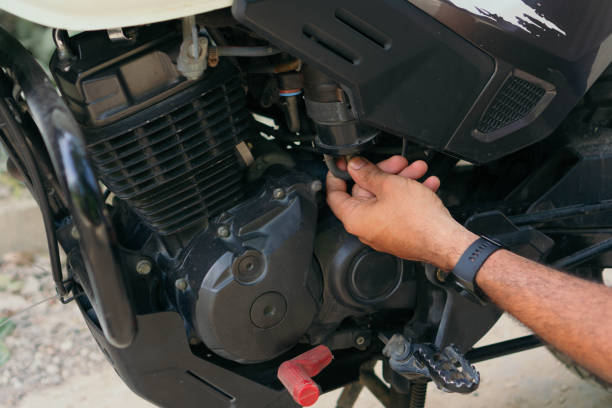 istock Man checking his motorcycle on a country road 1314413182