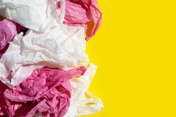 istock Crumpled plastic bags on yellow background. 1314413287