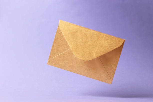 istock The envelope falls to the ground on a colored background. 1314413319