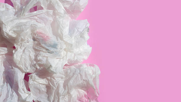 istock White crumpled plastic bags on pink background. 1314414245