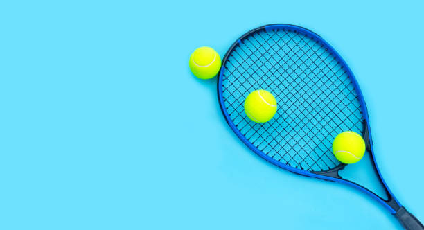 istock Tennis racket with balls on blue background. 1314414376
