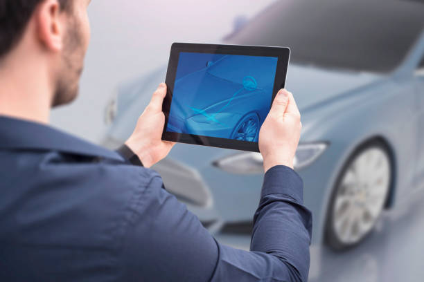 istock Over the shoulder view of a man using augmented reality for seeing the steering system on a car 1314414682