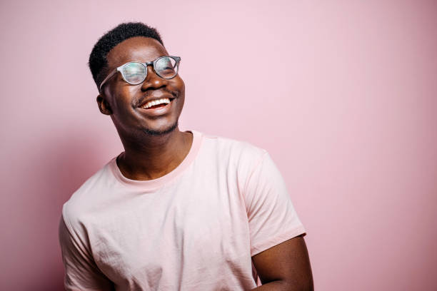 Always smile Portrait of handsome black man posing in front of pink background portrait stock pictures, royalty-free photos & images