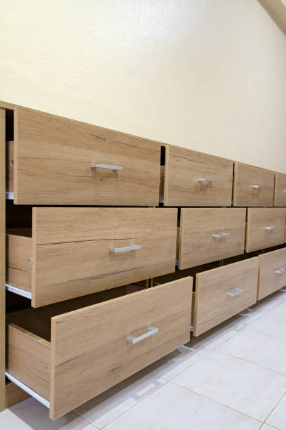 istock Wooden chest with open drawers against a cement wall background 1314416024