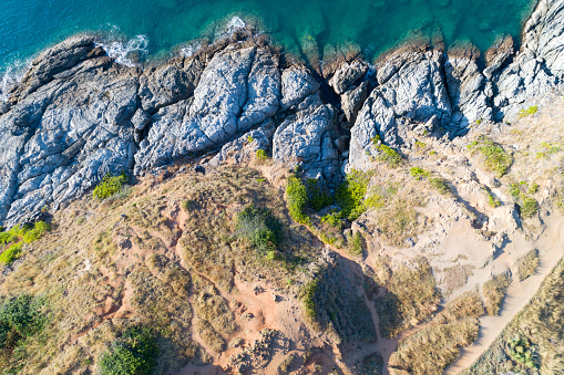 High angle view Tropical sea with wave crashing on seashore and high mountain located in Phuket Thailand aerial view drone top down Amazing nature Top view Seascape.