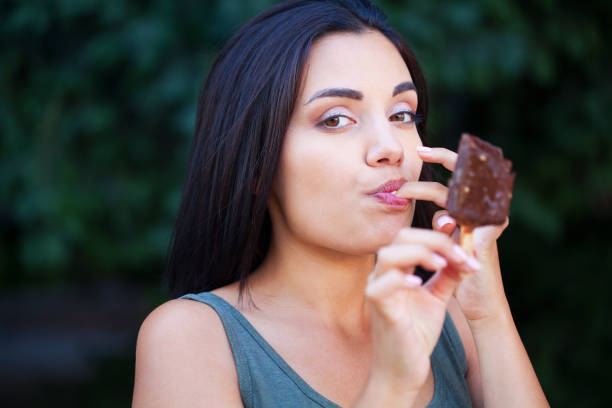 istock Beautiful woman eating ice-cream 1314416167
