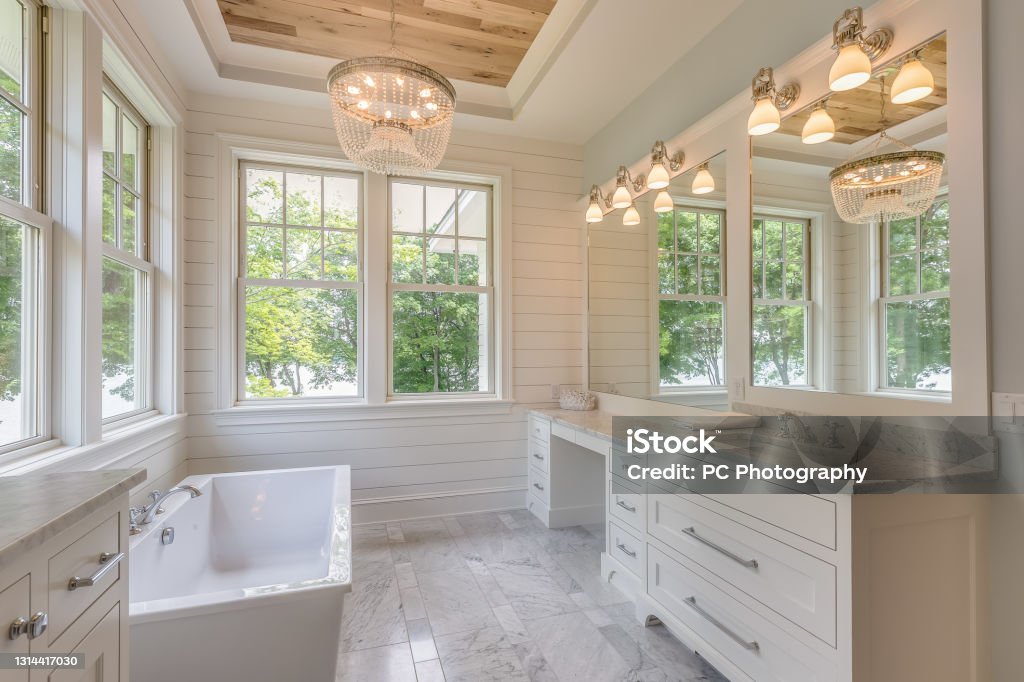 Gorgeous master bathroom with wood tray ceiling Free standing bathtub and white shiplap walls Bathroom Stock Photo