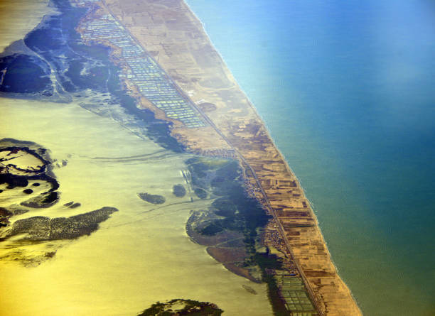 Burullus Lake and the Mediterranean coast - Nile Delta, Egypt Egypt, Kafr el-Sheikh Governorate: Burullus Lake and the Mediterranean coast, brackish water lake in the Nile Delta, east of Rosetta / Rashidseen - beaches, sandspit, islands, salterns, salt marshes, mud flats and reed beds - seen from the air. nile delta photos stock pictures, royalty-free photos & images