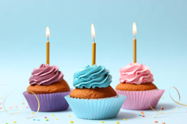 istock Delicious cupcake with a candle on a colored background 1314417051