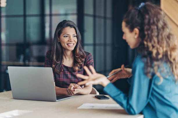 istock Two young women discussing business 1314417104