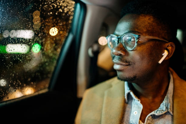 Coming late from work Young businessman in the back seat of the car black taxi stock pictures, royalty-free photos & images