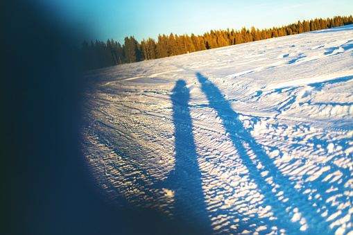 In Western Colorado Mountains Tall Shadows of Male and Female on Snow-Covered Ground in Grand Mesa National Forest Matching 4K Video Available (Shot with Canon 5DS 50.6mp photos professionally retouched - Lightroom / Photoshop - original size 5792 x 8688 downsampled as needed for clarity and select focus used for dramatic effect) Photographers in Photo