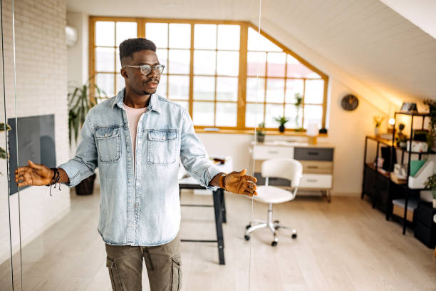 istock Young handsome man setting up glass door in his new office setup 1314418742