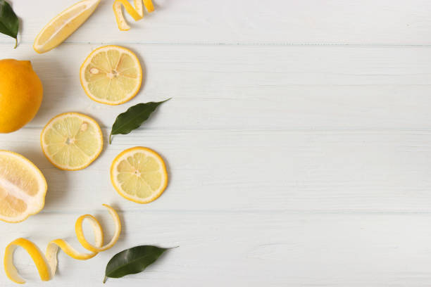 istock lemons and green leaves on a colored background. 1314419959