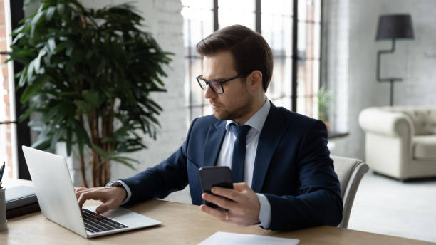 istock Serious businessman use modern electronic devices in office 1314422860