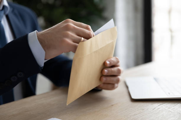 istock Close up of businessman open envelope with post letter 1314422911