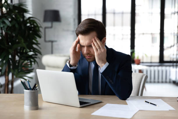 istock Unhealthy male employee struggle with headache at workplace 1314422930