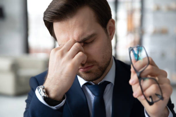 istock Exhausted male employee suffer from headache at workplace 1314422933