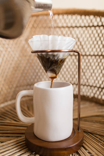 istock Making a Hot Pour Over Coffee in a Mid-Century Modern & Boho Style With a Rattan Background 1314426003