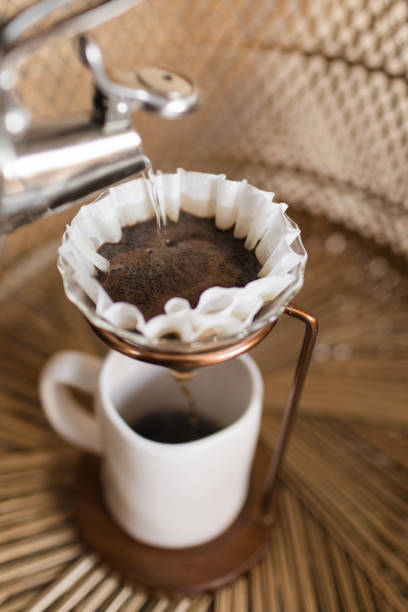 istock Making a Hot Pour Over Coffee in a Mid-Century Modern & Boho Style With a Rattan Background 1314426319