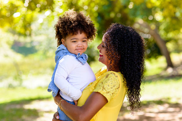 istock Mother and daughter having fun during walk in park 1314429127
