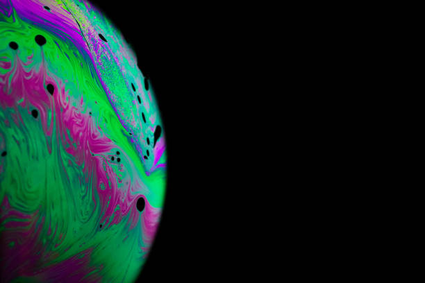istock Colourful bubbles. Abstract galaxy background with globe planet earth in universe space with sunlight on dark background. Abstract colorful soap bubble. 1314429842