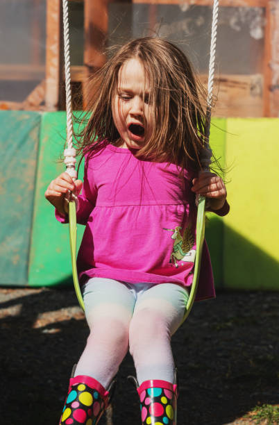 istock Girl Enjoys Swinging on Her Backyard Playground 1314435131