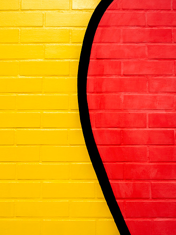 Yellow and red painted brick wall background.