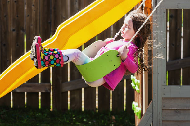 istock Girl Enjoys Swinging on Her Backyard Playground 1314435143