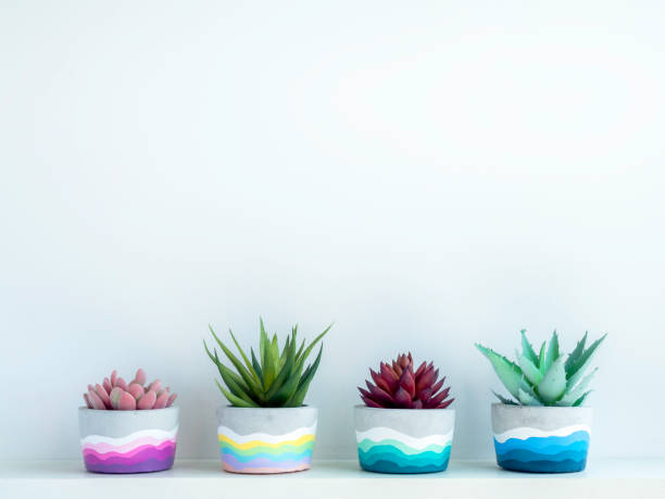 istock Colorful DIY concrete pot on wooden shelf. 1314435186