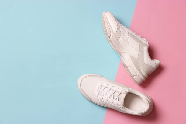 istock women's sneakers on a colored background top view. Women's shoes. 1314437414