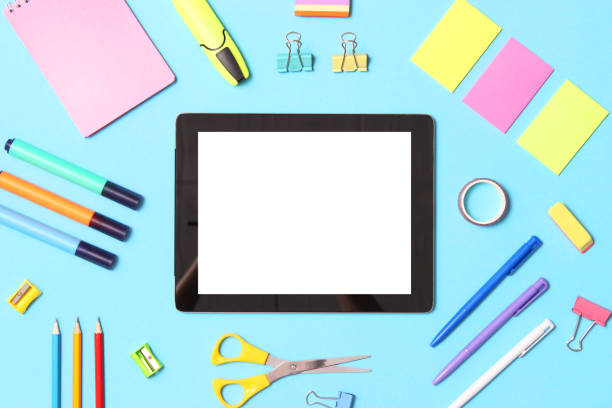 istock Modern digital tablet and school stationery on a colored background top view. 1314439108