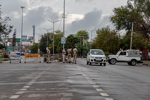 police checking at entry point to restrict people from entering delhi during lock down under COVID 19 conona virus pendmic.