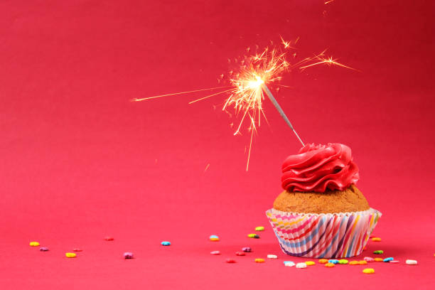 istock Delicious cupcake with a candle on a colored background 1314440675