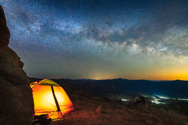 Mountain tent camping under the starry sky and Galaxy
