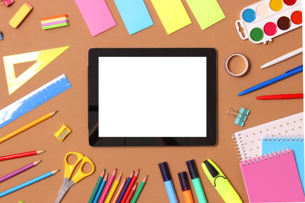 istock Modern digital tablet and school stationery on a colored background top view. 1314444624