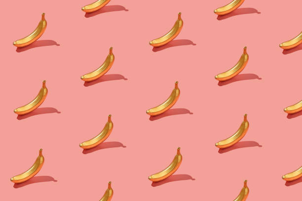 istock Trendy sunlight Summer pattern yellow banana  on bright light pink background. Minimal summer concept. 1314450442