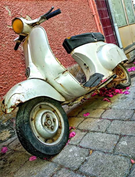 istock An old, unused motor scooter leaning against a wall. 1314451473