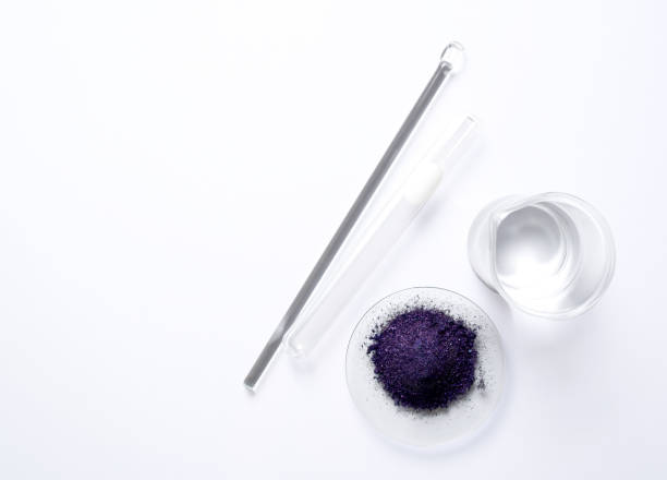 istock Cosmetic chemicals ingredient on white laboratory table. Potassium permanganate (KMnO4), Alcohol, stirring rod and test tube. Top view 1314452284