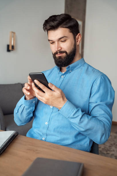 istock Millennial man blogger chatting online with followers using smartphone 1314452421