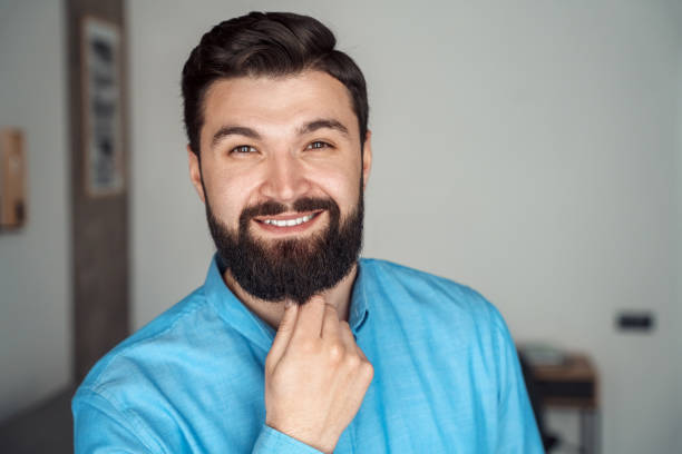 istock Headshot portrait of successful startup manager looking at camera touching beard 1314453283