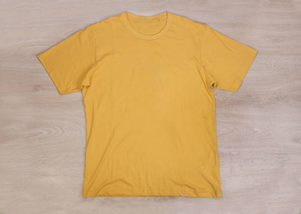 istock Front yellow tshirt on wooden background 1314454243