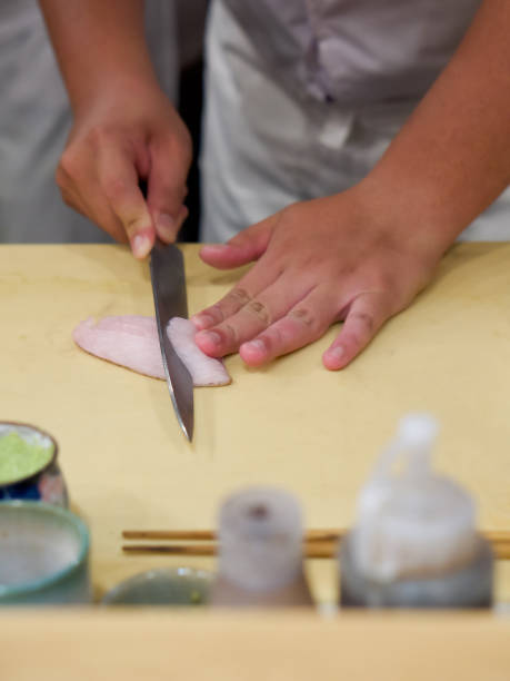 istock Chef use sharp knife slicing Aburi white fish for sashimi. Enjoy Omakase experience at Japanese Sushi Restaurant. 1314454429