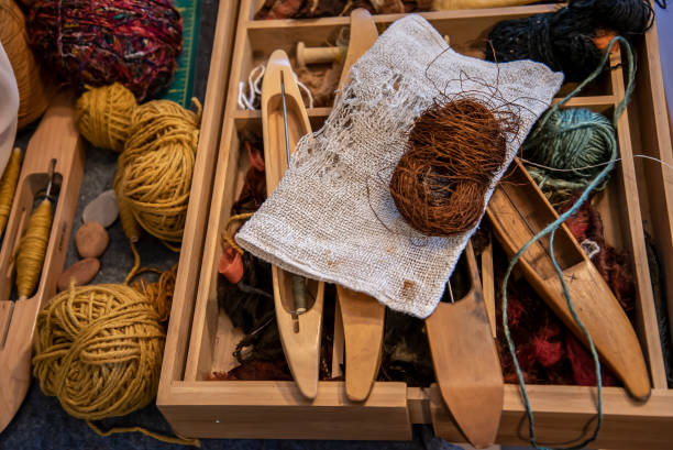 istock Collection of yarns and equipment on a silk weavers workshop table. 1314455430