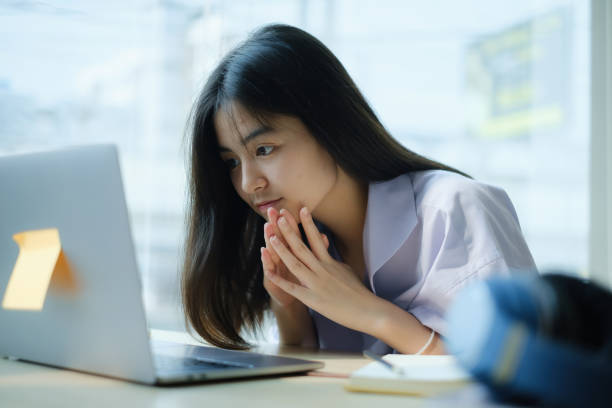 istock E-learning ,online ,education and internet social distancing protect from COVID-19 viruses concept. Asian woman student video conference e-learning with teacher on laptop computer at home. 1314456217