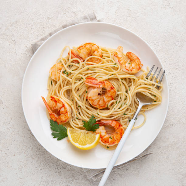 istock lemon and garlic shrims spaghetti pasta on white plate 1314456396