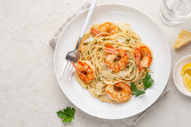 istock lemon and garlic shrims spaghetti pasta on white plate 1314456402