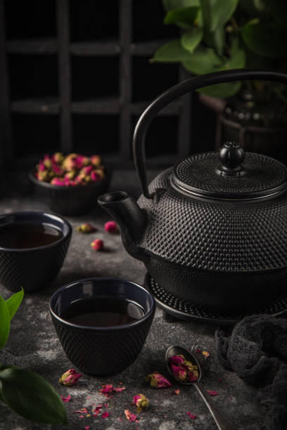 istock tea set. Cast iron eastern tea pot, cups and dry rose 1314457665