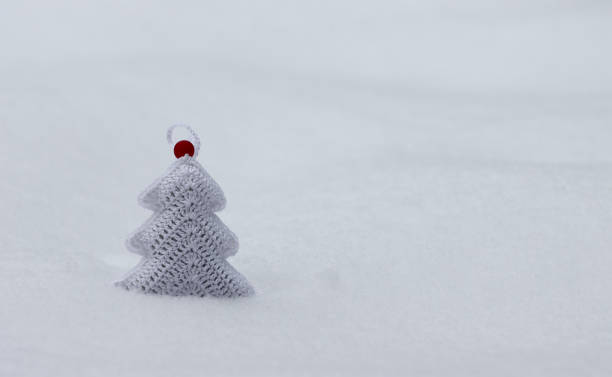 istock Knitted Christmas tree toy made of white threads. 1314458383